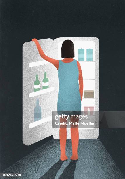 hungry woman standing at open refrigerator - open fridge stock-fotos und bilder