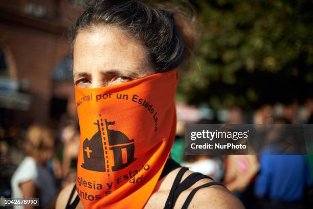 Woman holds a scarf calling for the separation between State and Church in Argentina. Women and men took to the streets of Toulouse for the...