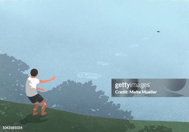 boy skipping stones at blue lake - skimming stones stock pictures, royalty-free photos & images