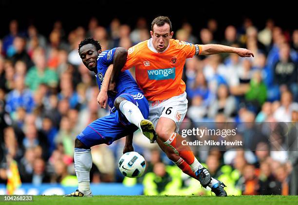 Michael Essien of Chelsea and Charlie Adam of Blackpool compete for the ball during the Barclays Premier League match between Chelsea and Blackpool...