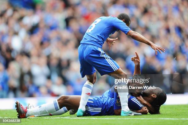 Didier Drogba of Chelsea lays on his back and celebrates with team mates Florent Malouda and Ashley Cole after scoring during the Barclays Premier...