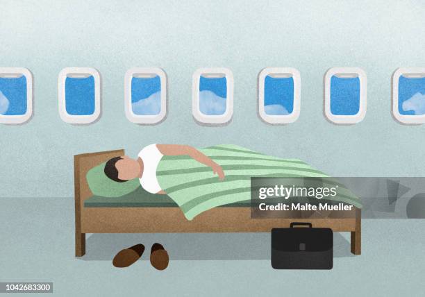 man sleeping on bed in airplane - business class reclining plane stock pictures, royalty-free photos & images