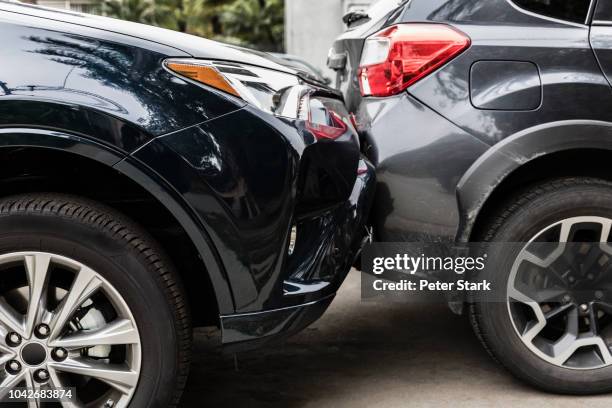 damaged bumpers from car accident - beat up car stockfoto's en -beelden