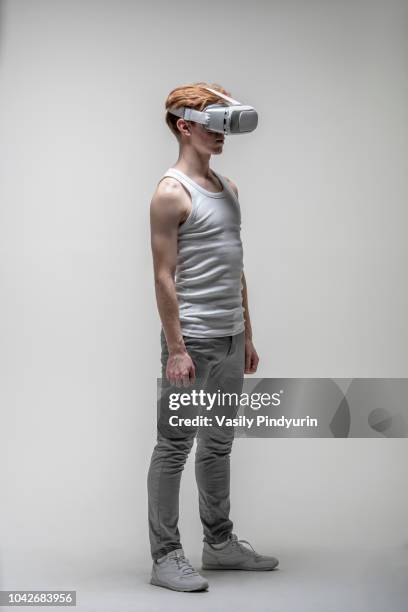 young man using virtual reality simulator glasses - top prospects game stockfoto's en -beelden