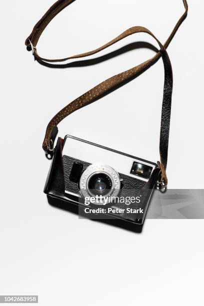 retro camera and strap on white background - spallina foto e immagini stock