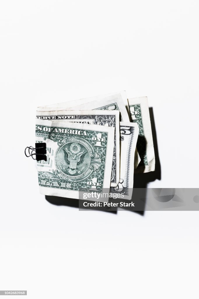 Clip holding folded one and five dollar bills