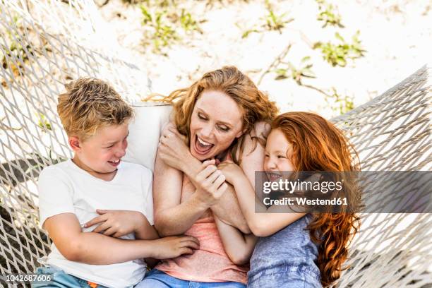 happy mother with children in hammock - tickling stock-fotos und bilder