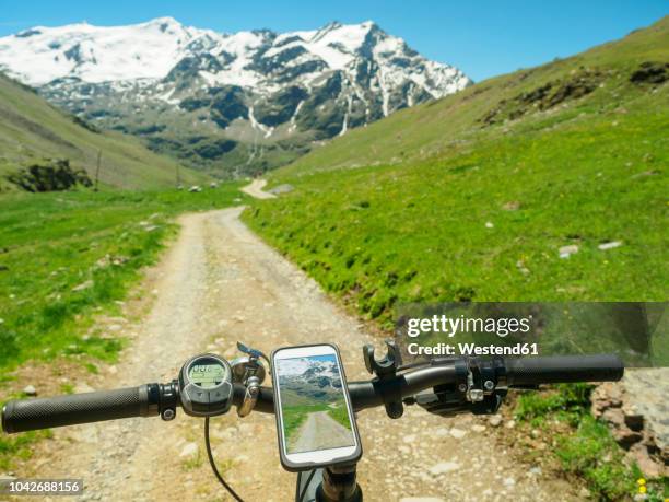 italy, lombardy, cevedale vioz mountain crest, cell phone on mountain e-bike - manillar fotografías e imágenes de stock