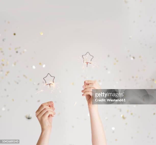 woman's hands holding sparklers - hand studio shot stock pictures, royalty-free photos & images