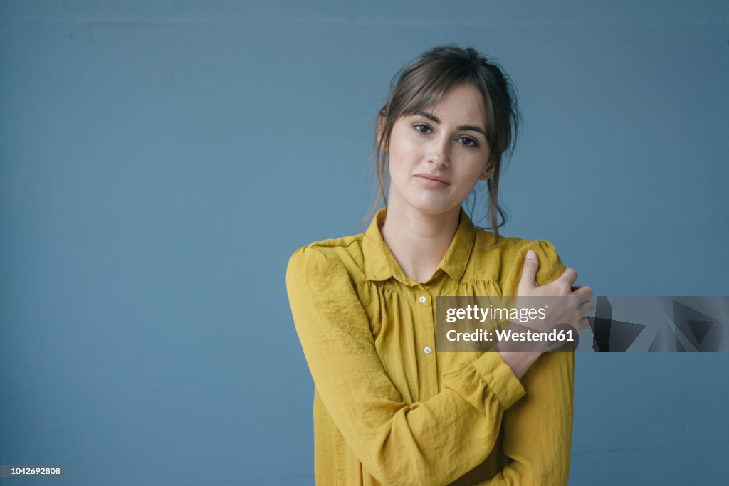 Portrait of a young woman wearing a yellow blouse