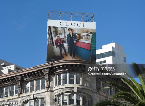 An advertising billboard promoting the Gucci clothing brand is mounted on top of a building in Union Square, in San Francisco, California.