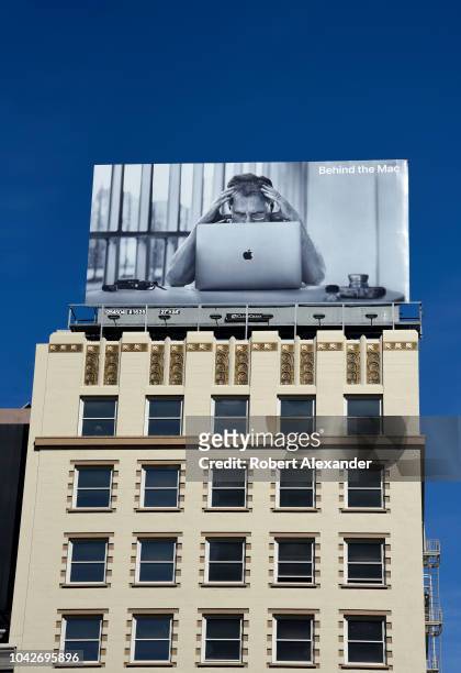 An billboard promoting the Mac, or Macintosh computers, part of Apple Inc.'s 2018 'Behind the Mac' advertising campaign, is mounted on top of a...