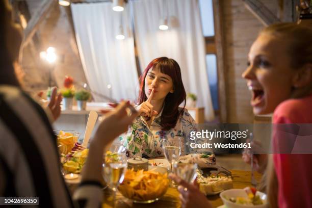 happy female friends having dinner at home together - woman hush stock pictures, royalty-free photos & images