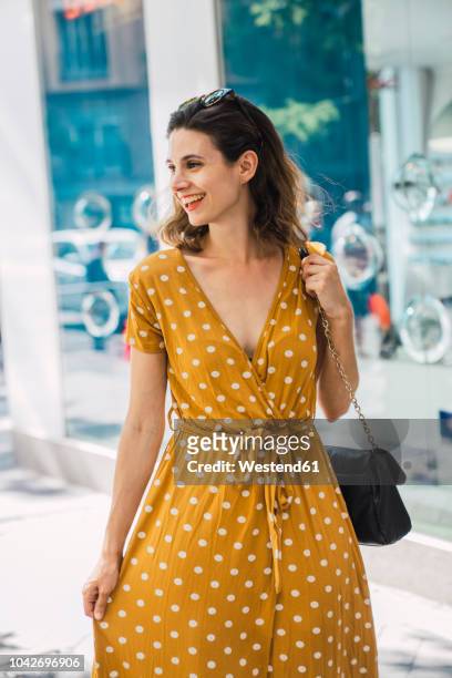 beautiful woman wearing yellow dress with polka dots - yellow dress stock pictures, royalty-free photos & images