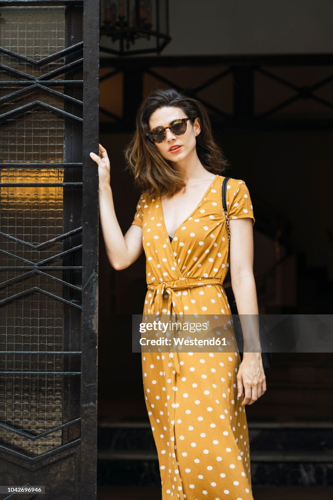 Beautiful woman wearing yellow dress with polka dots