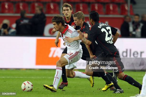 Dario Vidosic of Nuernberg eludes Arturo Vidal, Lars Bender and Stefan Reinartz of Leverkusen during the Bundesliga match between Bayer Leverkusen...