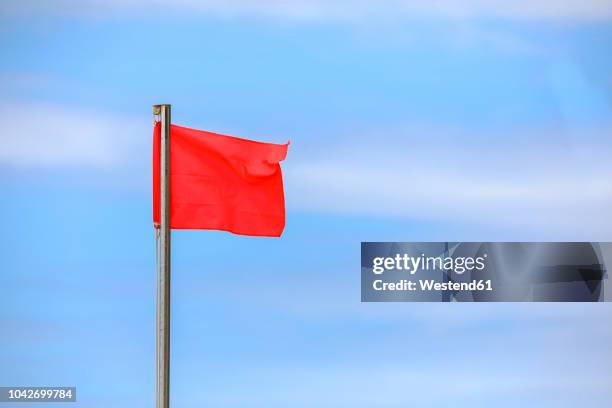 red flag blowing in the wind - red flag warning stock pictures, royalty-free photos & images