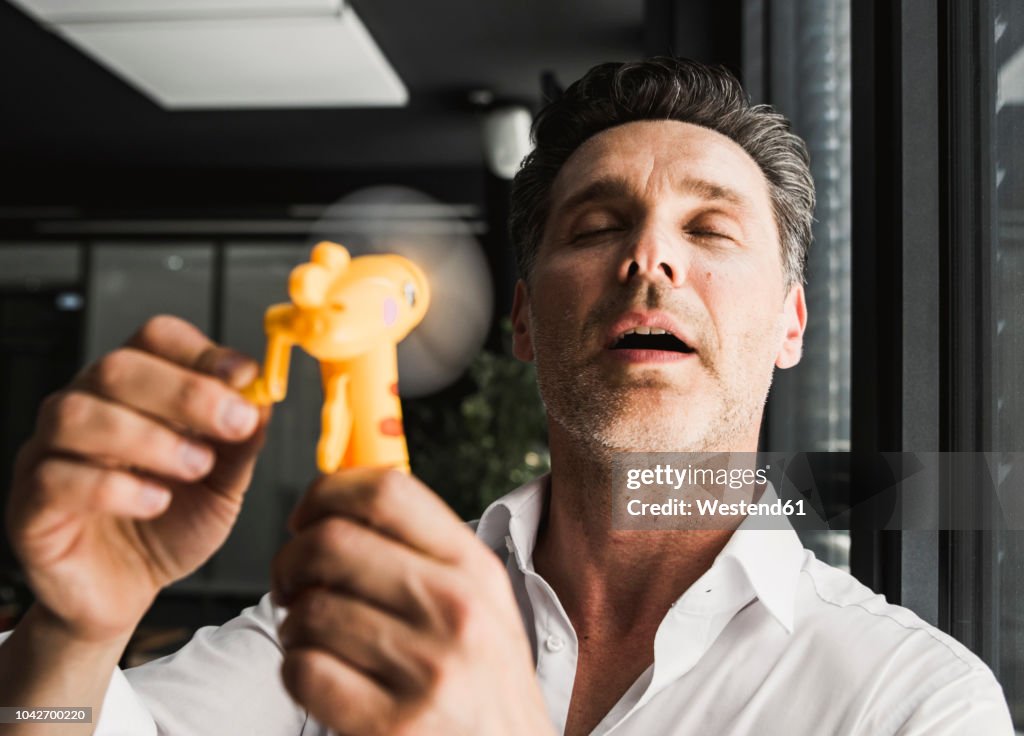 Businessman using hand fan in office