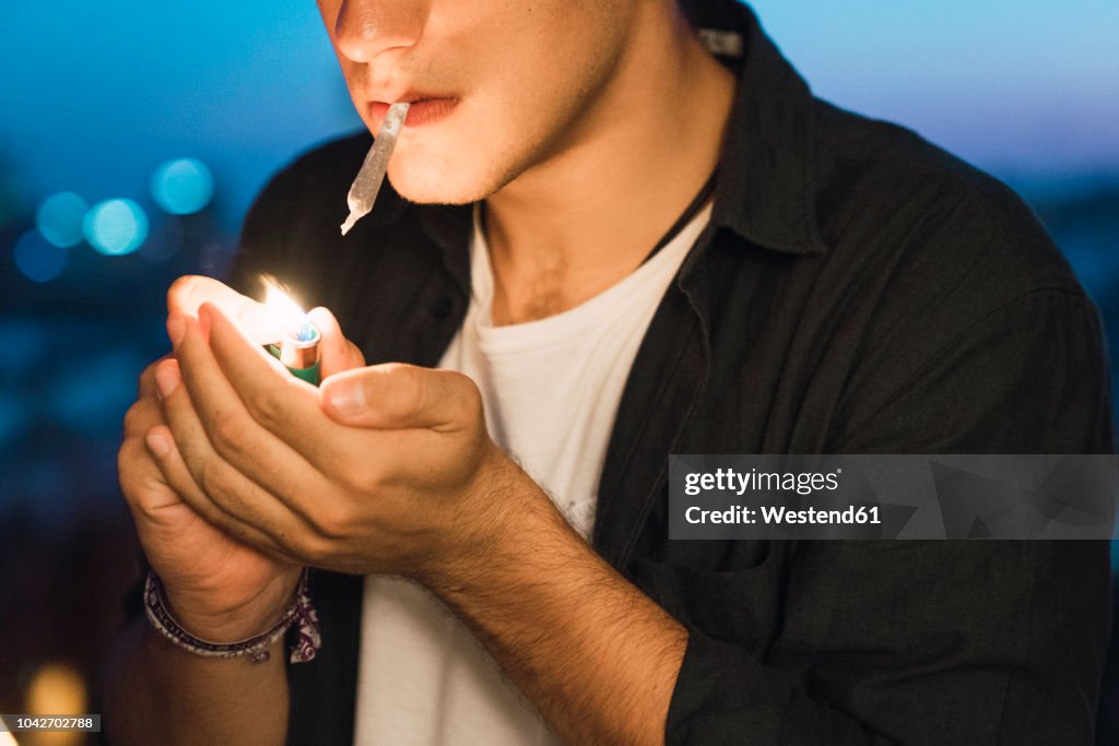 Young man smoking a joint
