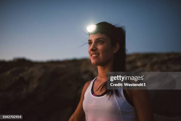 sportive woman with headlamp in the evening - head torch stock pictures, royalty-free photos & images