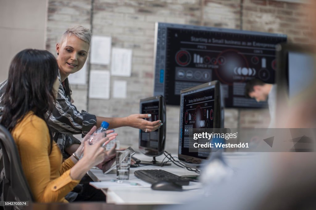 Adult Education, instructor talking to student at computer training centre