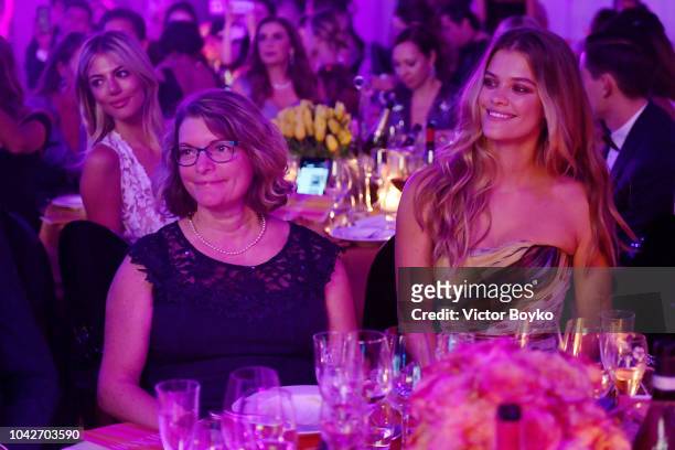 Anne-Mette Agdal and Nina Agdal are seen during the cocktail reception of amfAR Gala at La Permanente on September 22, 2018 in Milan, Italy.