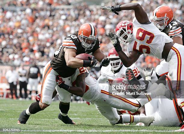 Running back Peyton Hillis of the Cleveland Browns runs the ball for a touchdown as he is hit by linebacker Jovan Belcher of the Kansas City Chiefs...