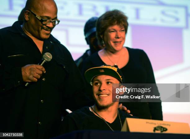 Denver South High School football coach Tony Lindsay Sr. Introduces player Phillip Lindsay and his parents, Diane and Troy, during a signing day...