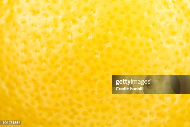 extreme close up of yellow lemon skin - lemon fruit stock pictures, royalty-free photos & images