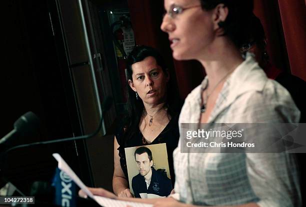 Recently-released hiker Sarah Shourd gives a statement while mother of a still-imprisoned hiker Cindy Hickey looks on holding a picture of her son...