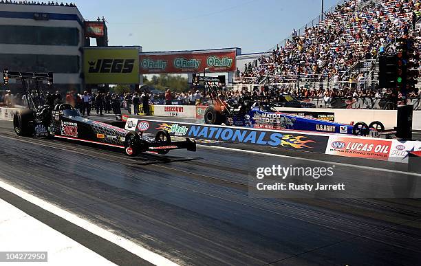 Tony Buff, driver of the Bill Miller Racing Top Fuel Dragster races Antron Brown, driver of the Matco Tools Top Fuel Dragster during the O'Reilly...