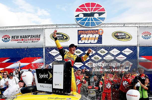 Clint Bowyer, driver of the Cheerios / Hamburger Helper Chevrolet, celebrates with his crew in victory lane after he won the NASCAR Sprint Cup Series...