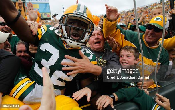 Brandon Jackson of the Green Bay Packers celebrates a touchdown with a "Lambeau Leap" into the stands against of the Buffalo Bills at Lambeau Field...