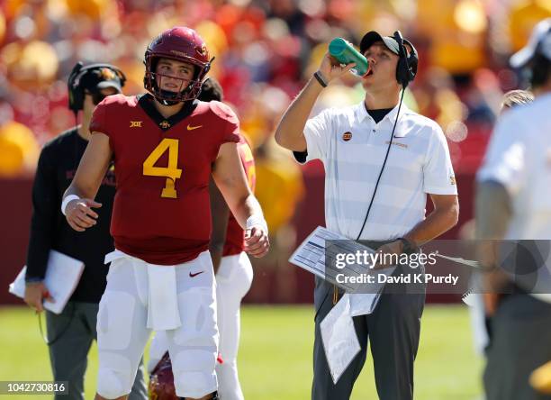 Quarterback Zeb Noland of the Iowa State Cyclones stretches as head coach Matt Campbell of the Iowa State Cyclones takes a drink during a time out in...