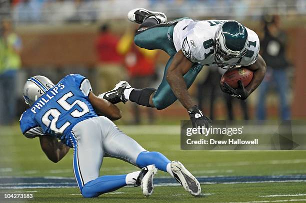 Wide Receiver Jason Avant of the Philadelphia Eagles gets a fist down as he is upended by defensive back Randy Phillips the Detroit Lions on...