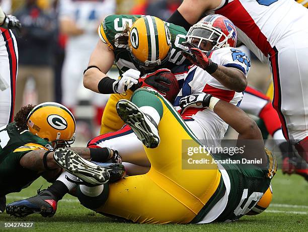 Nick Barnett, A.J. Hawk and B.J. Raji of the Green Bay Packers bring down Fred Jackson of the Buffalo Bills at Lambeau Field on September 19, 2010 in...