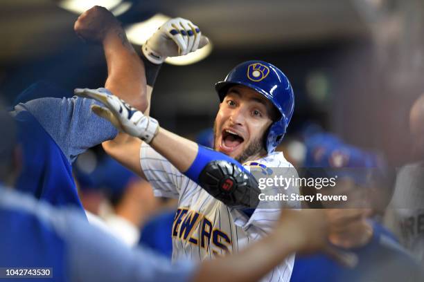 Ryan Braun of the Milwaukee Brewers is congratulated by teammates following a solo home run against the Detroit Tigers during the eighth inning of a...
