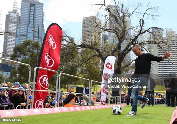 Former Melbourne Victory soccer player Archie Thompson kicks during AFL Grand Final Day Fox Footy's kicking competition at Birrarung Marr on...