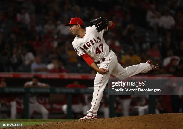 Pitcher Junichi Tazawa of the Los Angeles Angels of Anaheim pitches during the eighth inning of the MLB game against the Oakland Athletics at Angel...