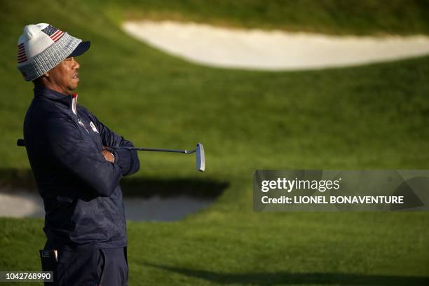 Golfer Tiger Woods reacts during his fourball match on the second day of the 42nd Ryder Cup at Le Golf National Course at Saint-Quentin-en-Yvelines,...