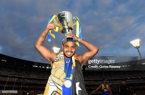 Willie Rioli of the Eagles holds up the Premiership Trophy after the Eagles won the 2018 AFL Grand Final match between the Collingwood Magpies and...