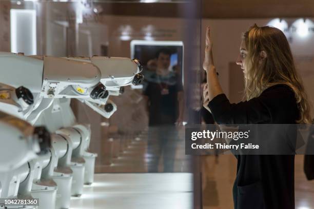 Manus, a project designed by Madeline Gannon where interconnected industrial robots interact with humans, is displayed at the Annual Meeting of the...
