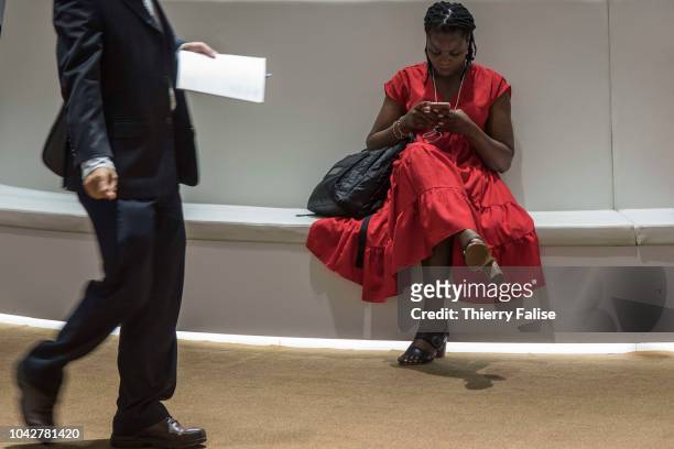An African female participant reads her mobile phone during the Annual Meeting of the New Champions of the World Economic Forum held in Tianjin from...