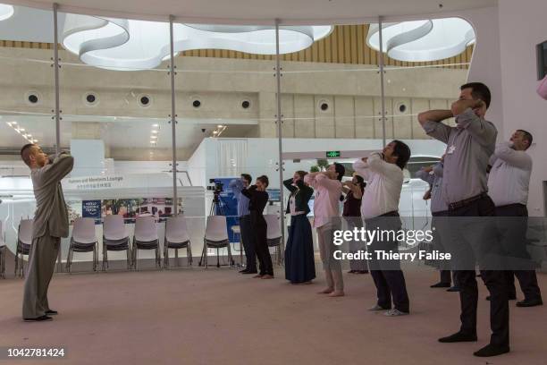 Participants attend a taichi workshop during the Annual Meeting of the New Champions of the World Economic Forum held in Tianjin from September 18 to...