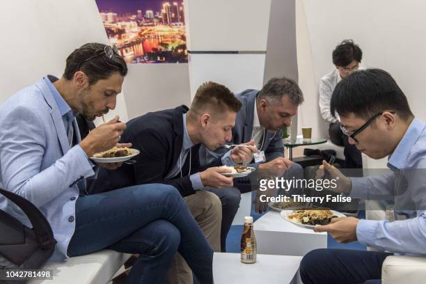 Participants take their lunch during the Annual Meeting of the New Champions of the World Economic Forum held in Tianjin from September 18 to 20,...