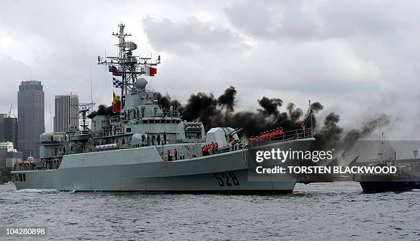 China's People's Liberation Army naval frigate 'Mianyang' belches smoke as she manoeuvres in Sydney Harbour on September 20, 2010. The ship's visit...
