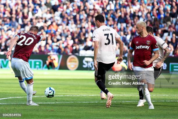 Andriy Yarmolenko of West Ham United shot at goal is deflected of Nemanja Matic of Manchester United for the second West Ham United goal during the...