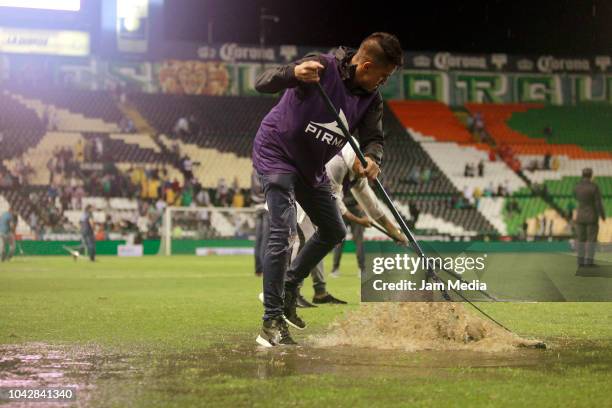 Support staff takes the water out of the field during the 10th round match between Leon and Lobos BUAP as part of the Torneo Apertura 2018 Liga MX at...