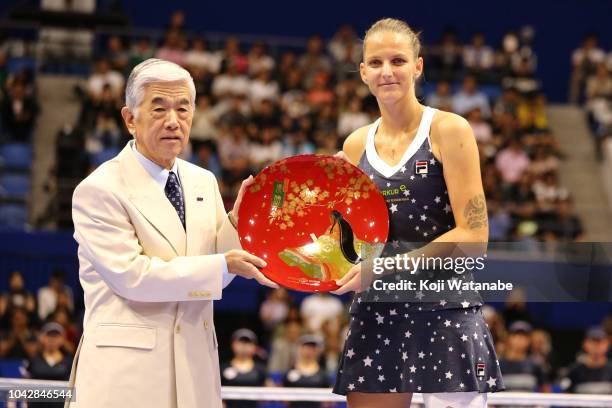 Singles champion Karolina Pliskova of the Czech Republic receives the trophy after the Singles final against Naomi Osaka of Japan on day seven of the...