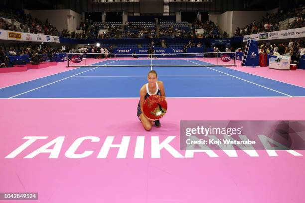 Singles champion Karolina Pliskova of the Czech Republic poses for photographs with the trophy after the Singles final against Naomi Osaka of Japan...